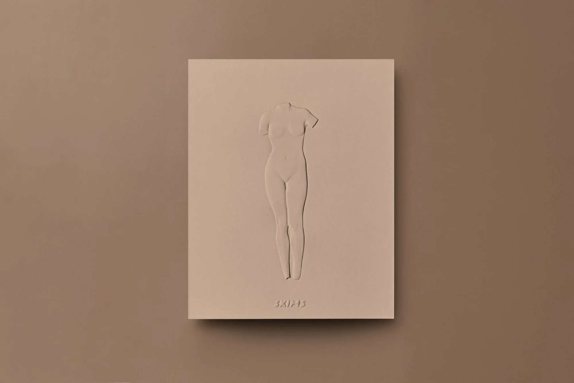 Beige studio shot features a 3D sculpture of a headless female torso mounted on a matching block with minimal surface textures.