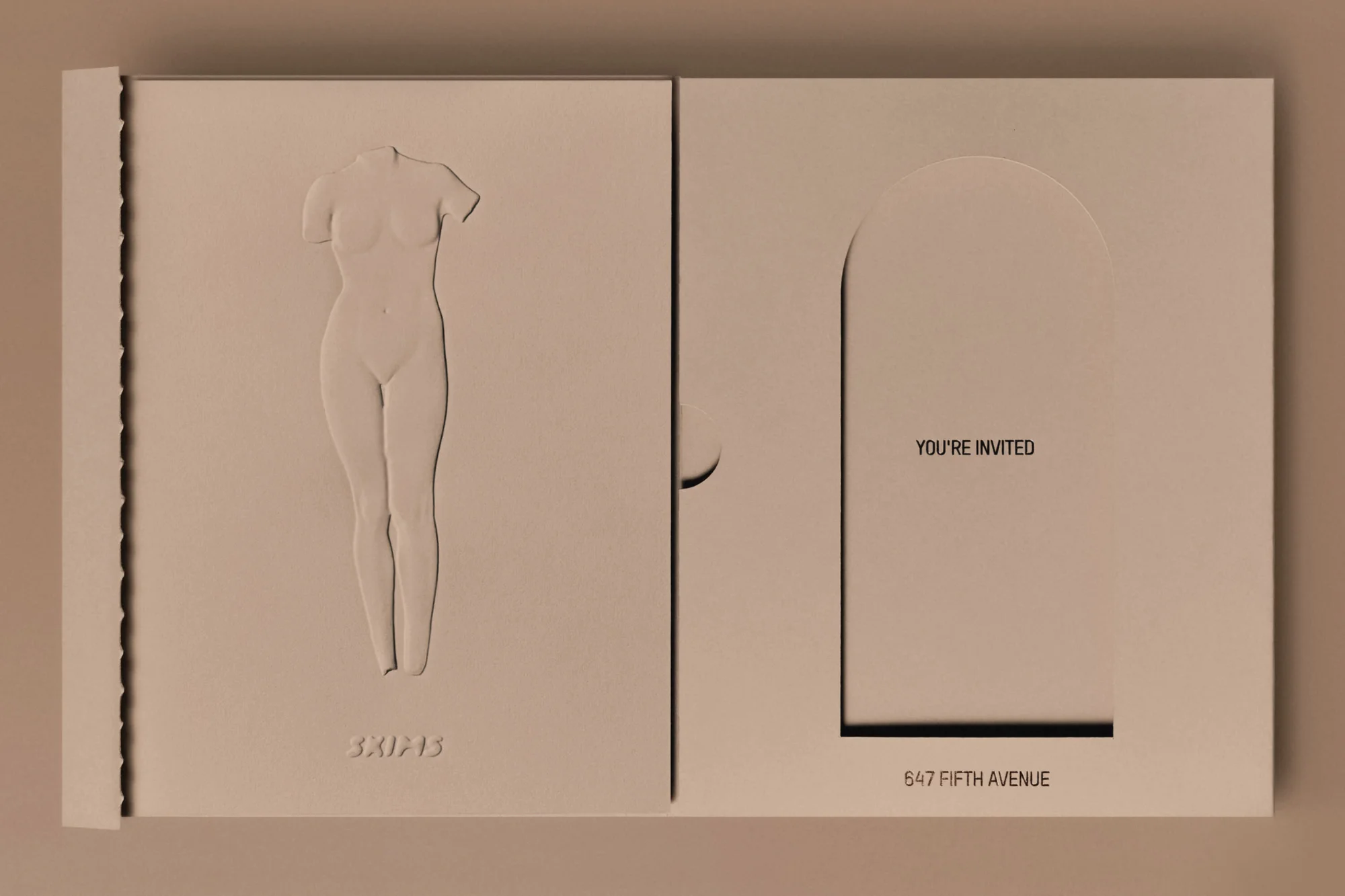 Invitation card with a nude female body bas-relief and a minimalist archway design, presented in a light beige color palette.