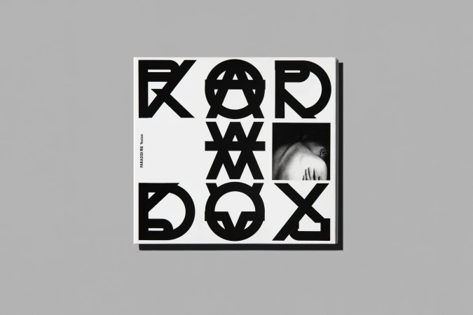 Monochrome image of a PARADOX WE Tension album cover featuring typographic design and a black and white human figure. 