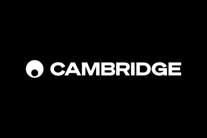 Cambridge logo featuring a distinctive circular icon and bold, white lettering set against a solid black background. Minimalist design.