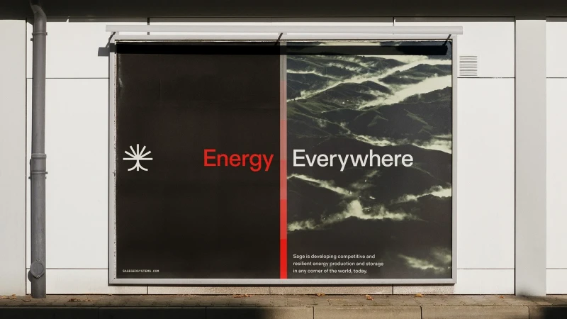 Outdoor advertisement featuring an energy company with black, red, and white text against a mountain landscape backdrop on a building.