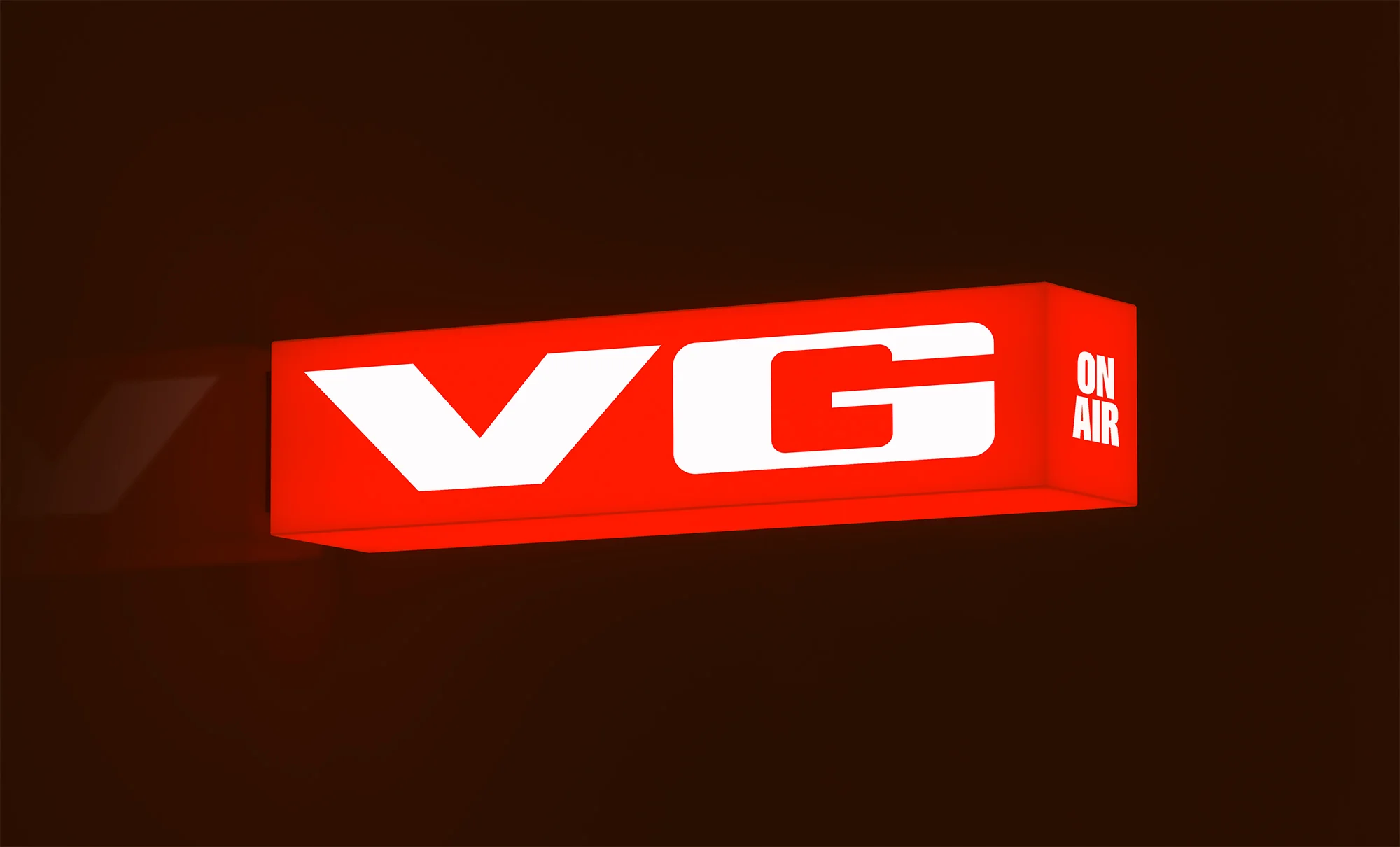 Illuminated red box with white letters 'VG' and 'On Air' against a dark background, suitable for broadcasting or entertainment content.