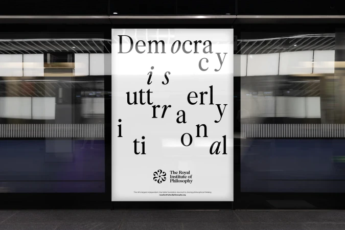 Poster in a subway station features typography art with scattered letters, promoting the Royal Institute of Philosophy and philosophical thinking.