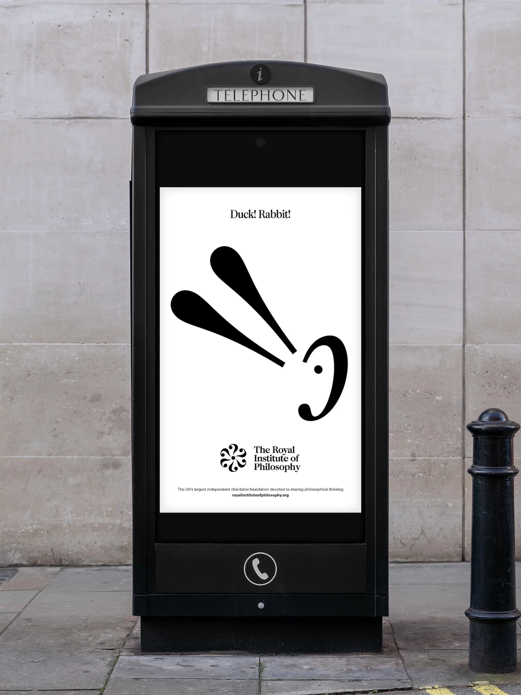 A black British telephone box displays a black and white advertisement for the Royal Institute of Philosophy, featuring a duck/rabbit optical illusion.