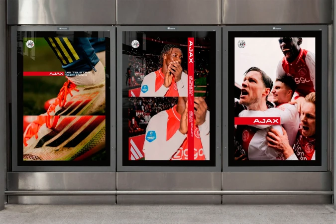Outdoor posters showcase Adidas soccer cleats, and soccer players in uniform. The brand name AJAX is prominently displayed on posters.
