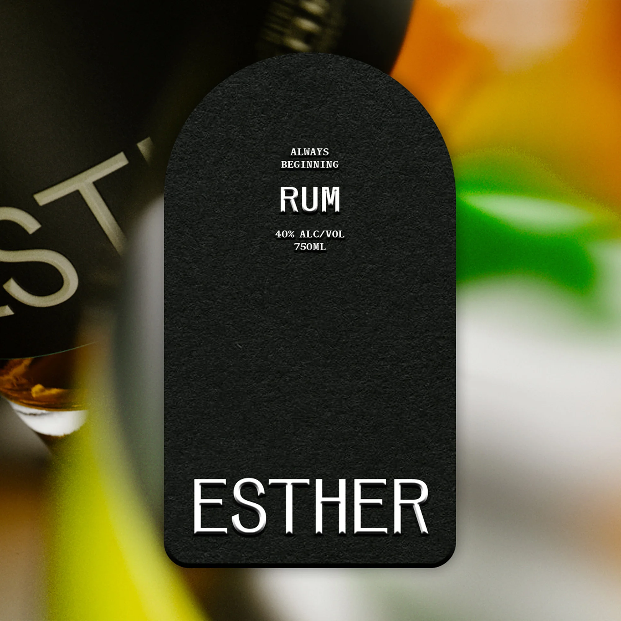 Close-up of an 'Esther' rum bottle with a black arched label displaying the brand name, alcohol percentage, and volume.