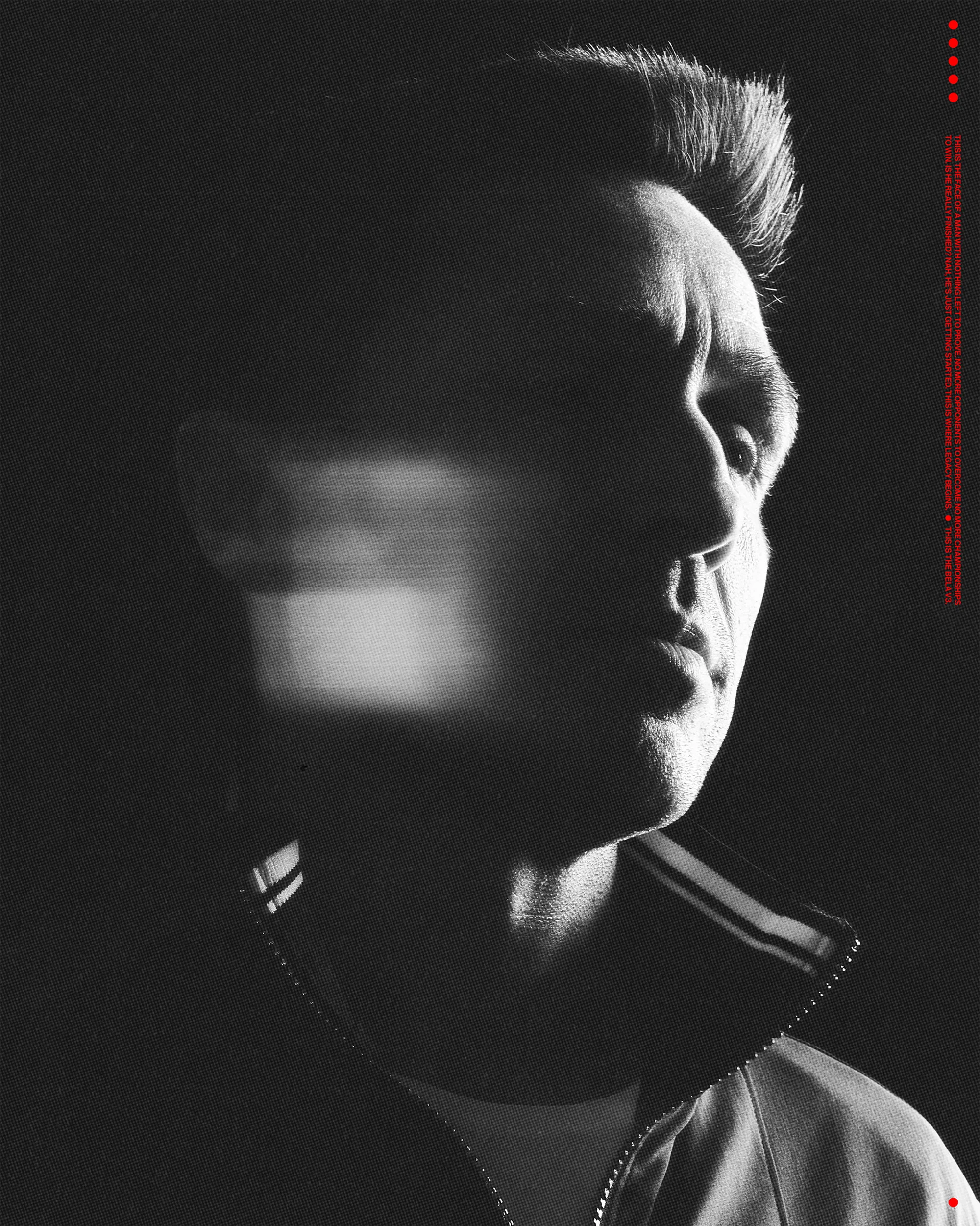 Monochrome portrait of a man in a track jacket with motion blur over his face against a dark background with red dots on the right.