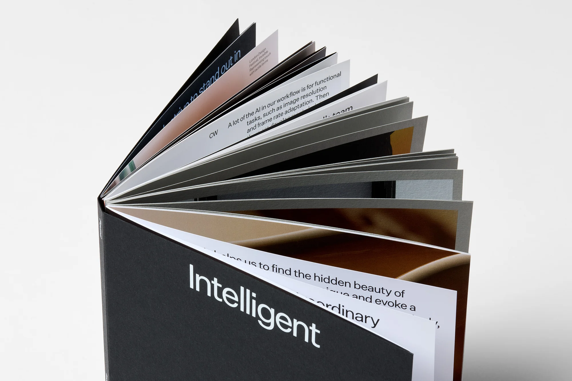 Open black book with bright white pages, showcasing an 'Intelligent' text layout, set against a clean, minimalist background.