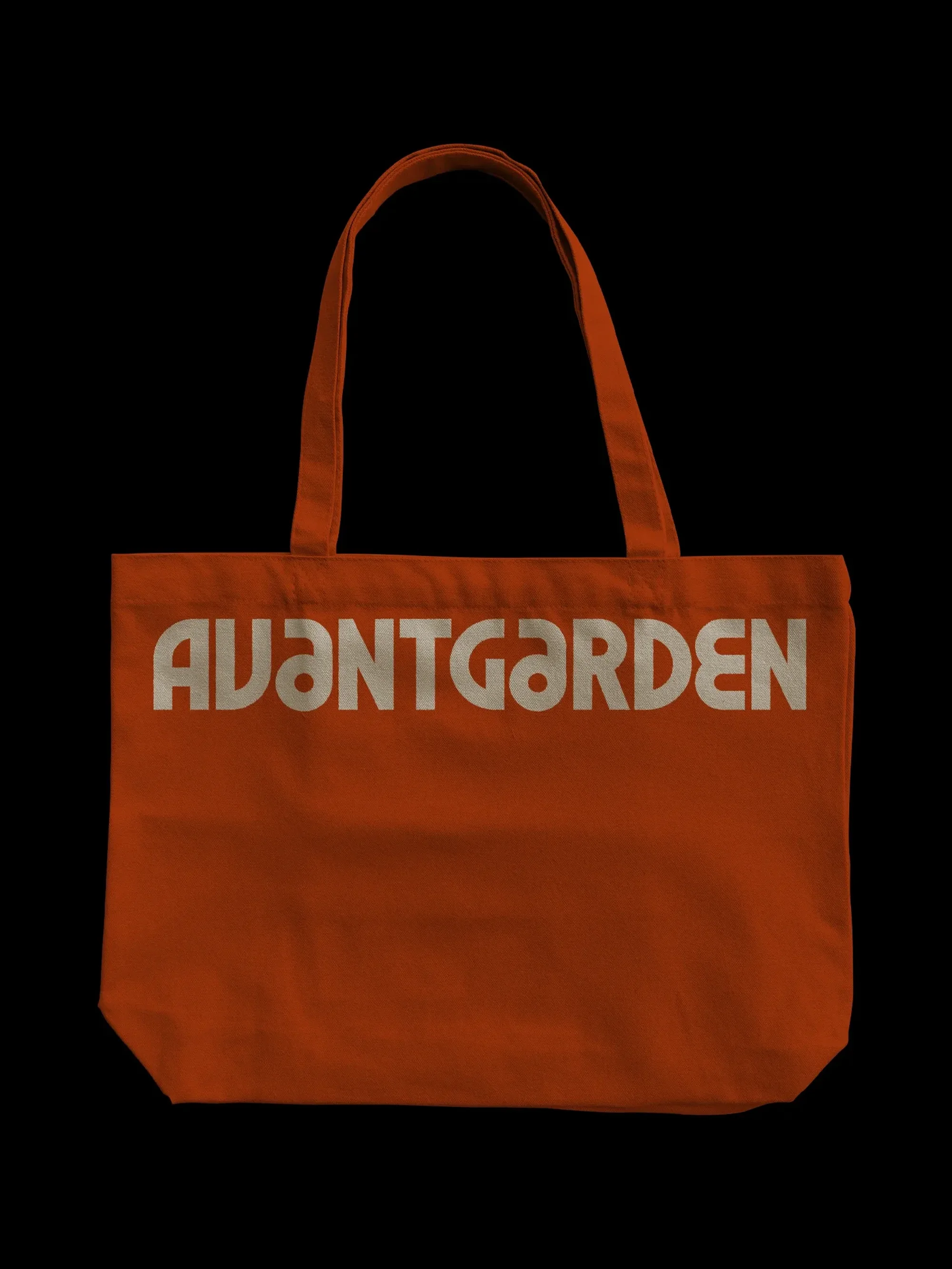 Orange tote bag with white sans-serif 'AVANTGARDEN' text displayed in studio setting on a black background.