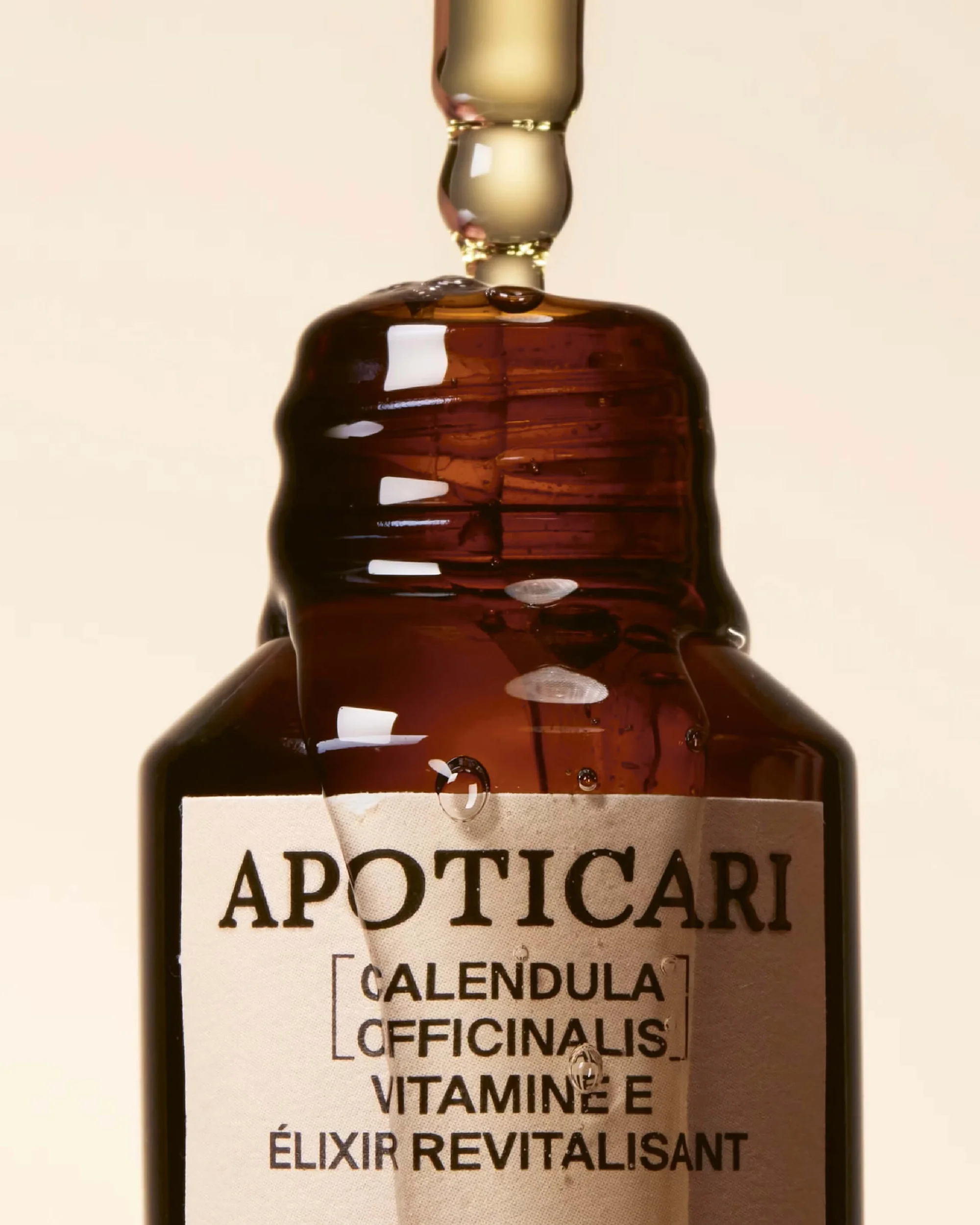 Close-up of a brown glass apothecary bottle with a dropper, showcasing the bottle's label and the liquid inside the dropper.