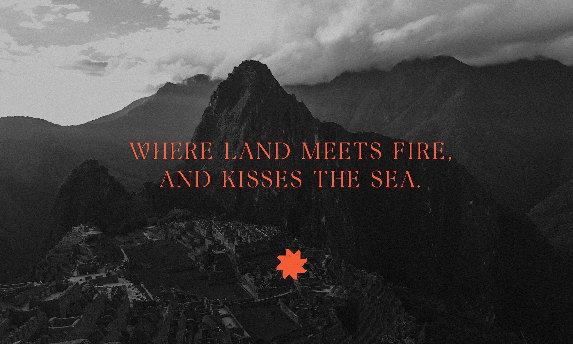 High-angle view of Machu Picchu ruins in Peru surrounded by mountains with text overlay saying, 'Where land meets fire, and kisses the sea.'