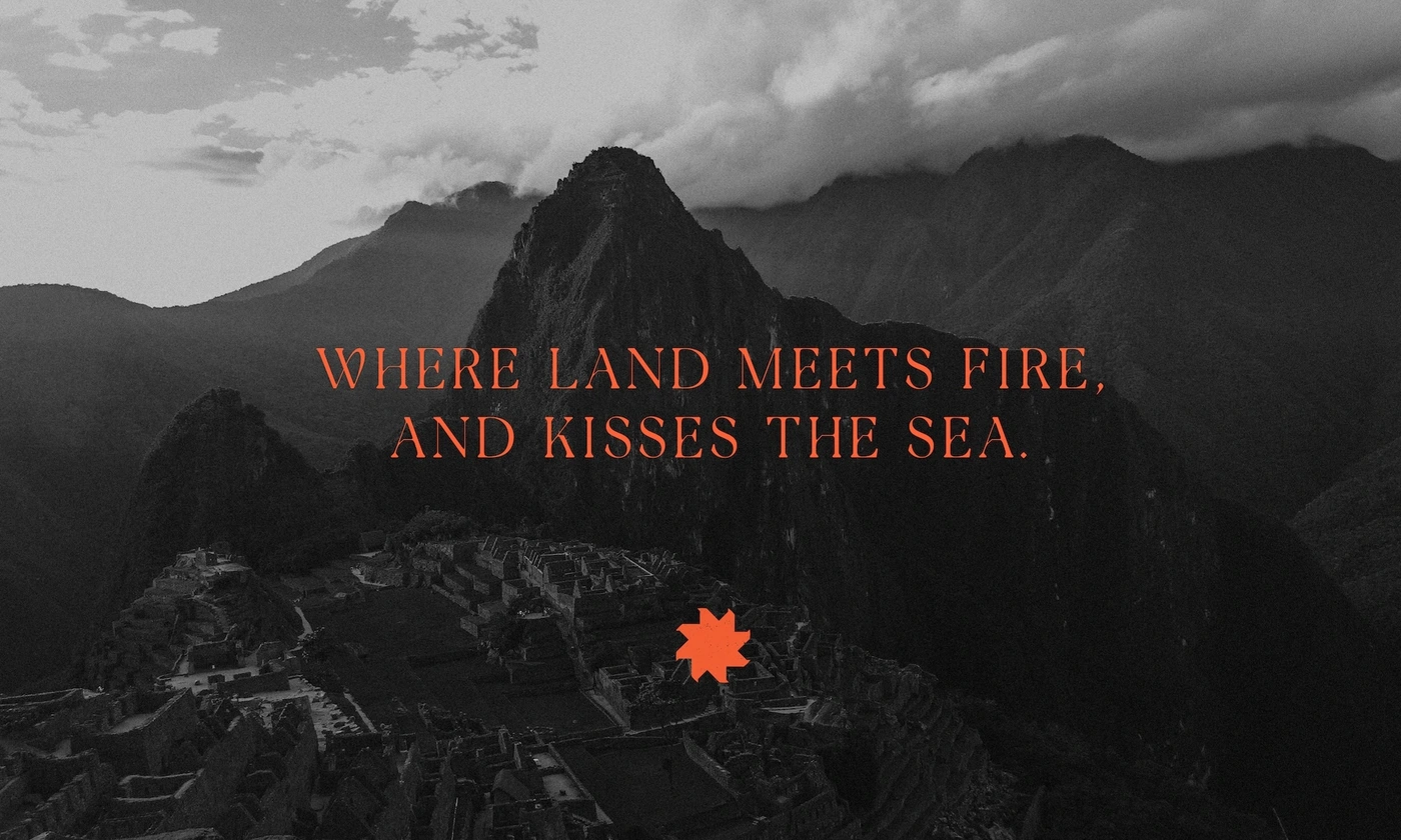 Black and white aerial view of a mountain landscape with overlapping typographic quote and red geometric logo