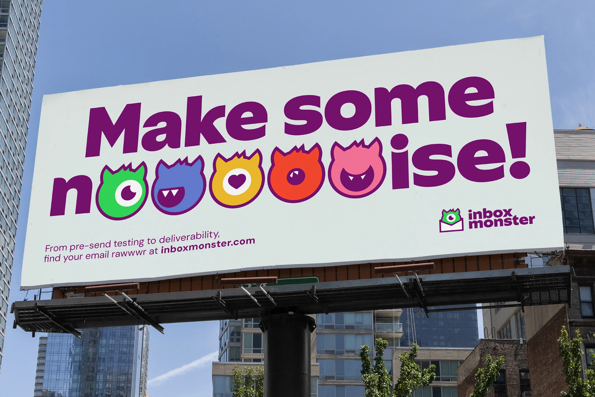 Outdoor billboard with text 'Make Some Noise!' and colorful monster icons, advertising Inbox Monster email marketing services, urban background.