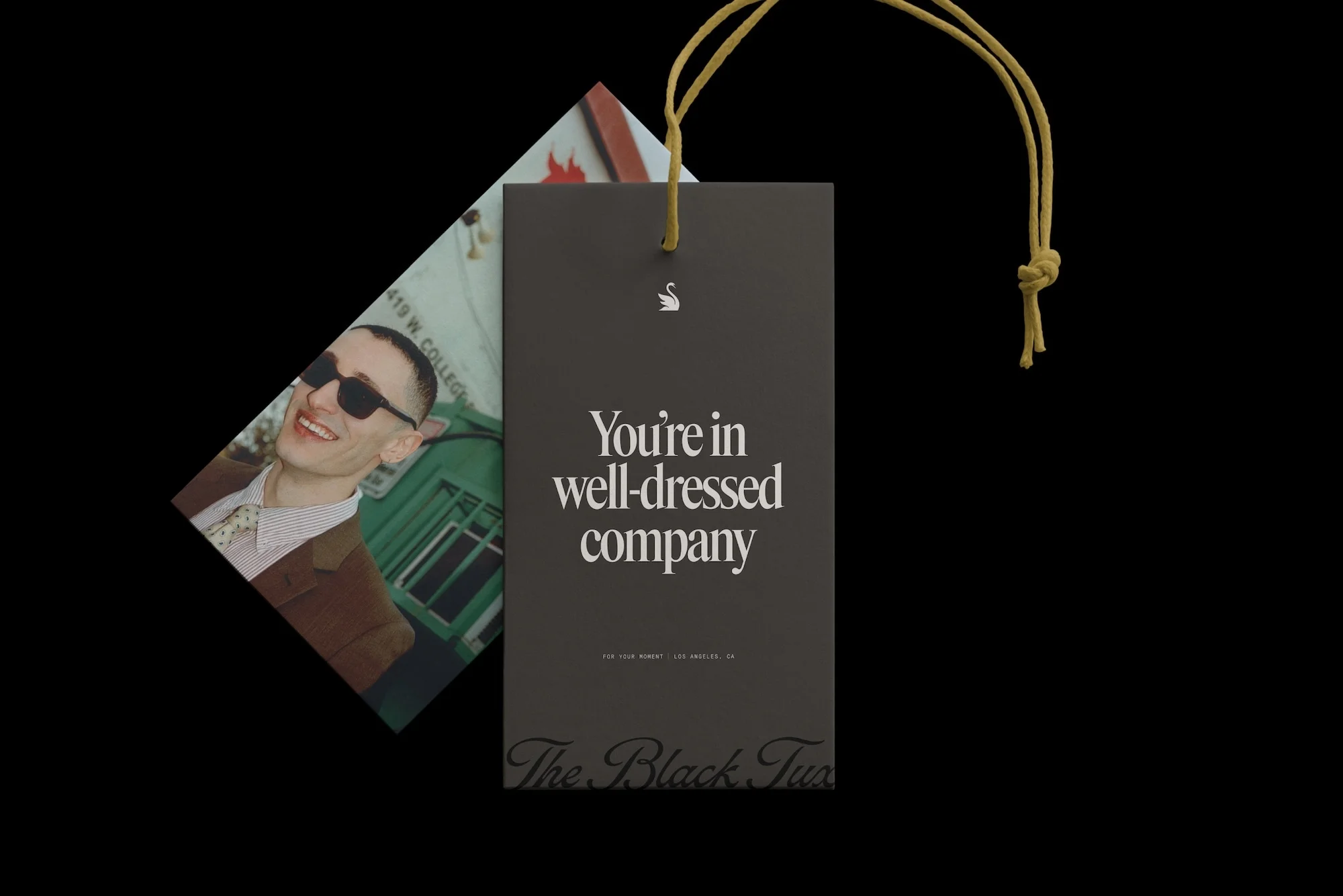 Promotional image featuring a tag with the text 'You're in well-dressed company' alongside a card with a smiling man.