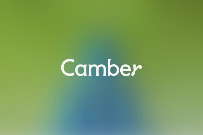 The word 'Camber' in a white handwritten-style font over a gradient blue-to-green background with a blurred, out-of-focus appearance.