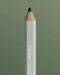 Close-up macro shot of a white pencil tip with Camber branding against a muted green background.