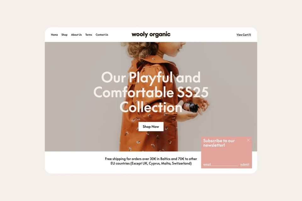 Online retail website for Wooly Organic brand featuring child model wearing dress, promoting playful and comfortable SS25 collection.