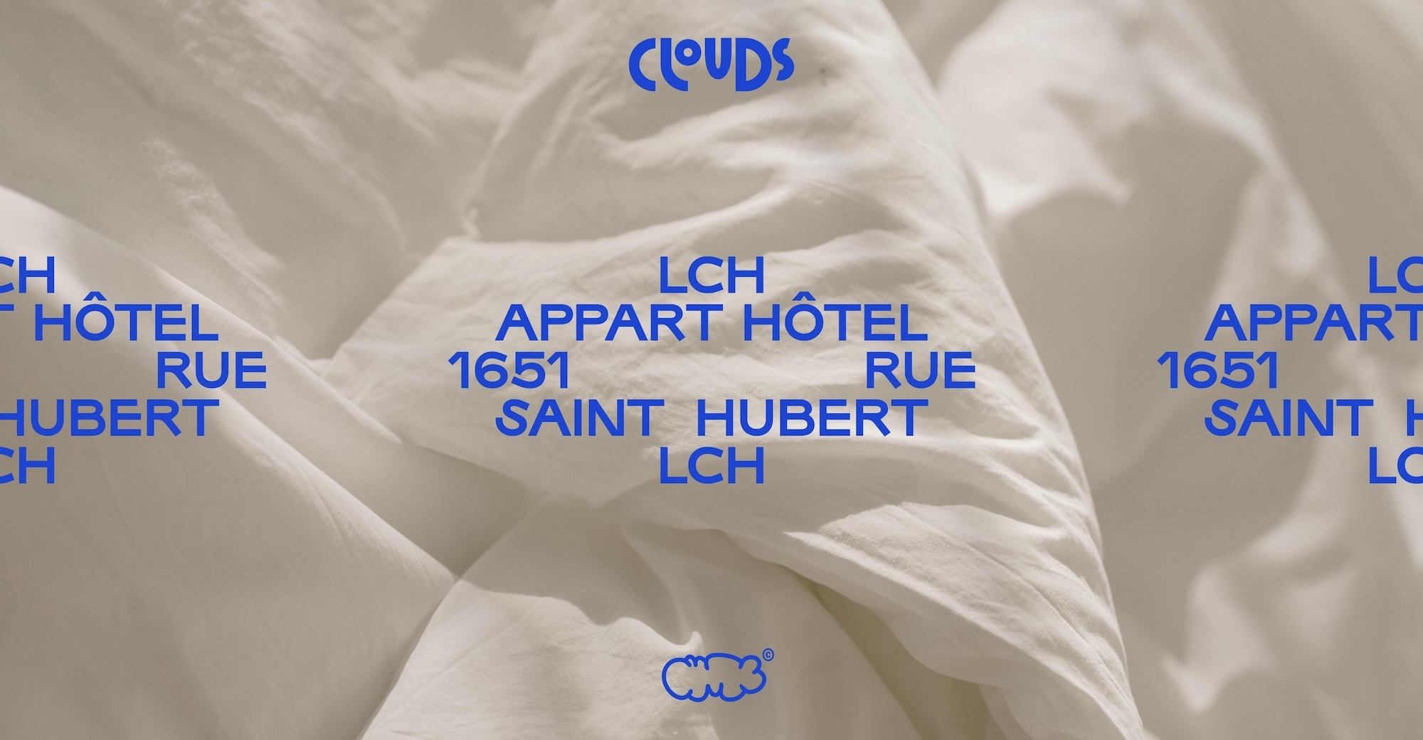 White duvet cover with blue text overlay reads Clouds, LCH Appart Hotel, and Saint Hubert, creating a modern, minimalist design.