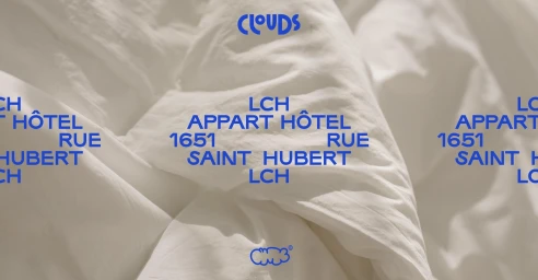 Blue typographic brand identity overlay featuring Hotel Clouds on a textured white fabric background