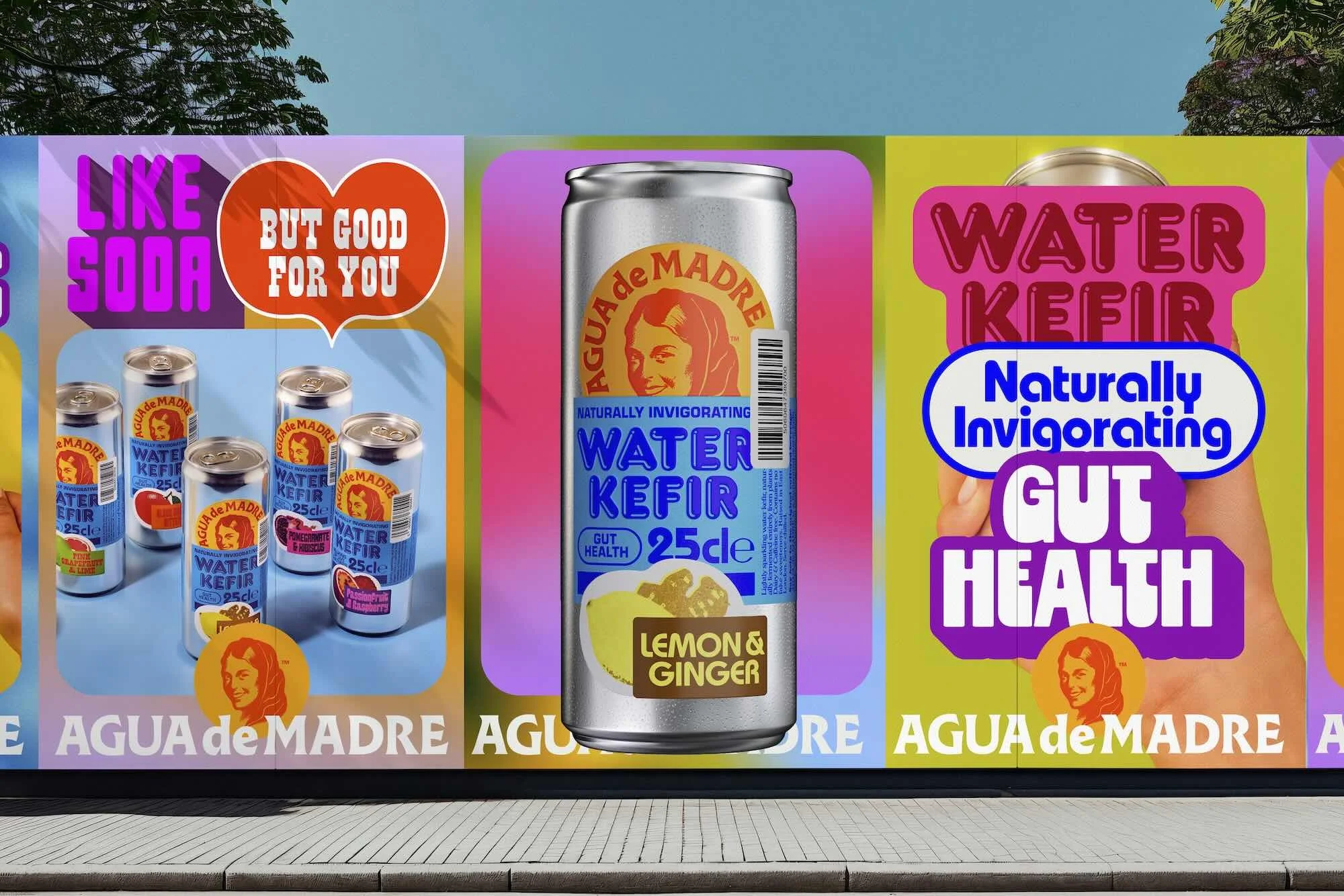 Brightly colored advertising mural featuring Agua de Madre water kefir cans with fruit flavors, promoting gut health on an urban wall.
