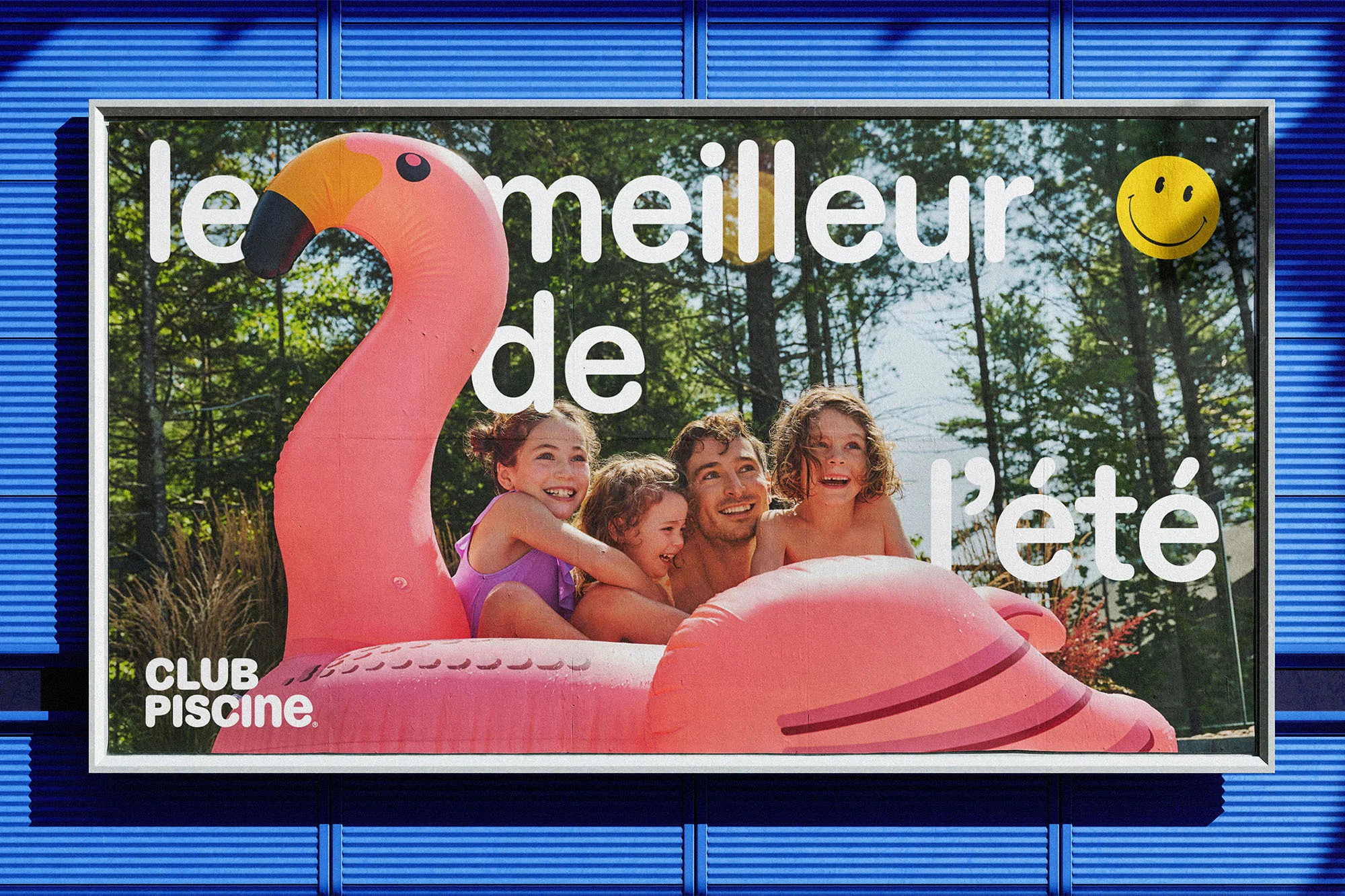 Advertising billboard featuring a family on a pink flamingo float in a pool, promoting Club Piscine with a smiling sun graphic.