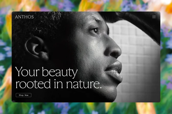 Anthos skincare ad in black and white featuring an African American woman in profile, with a floral background.