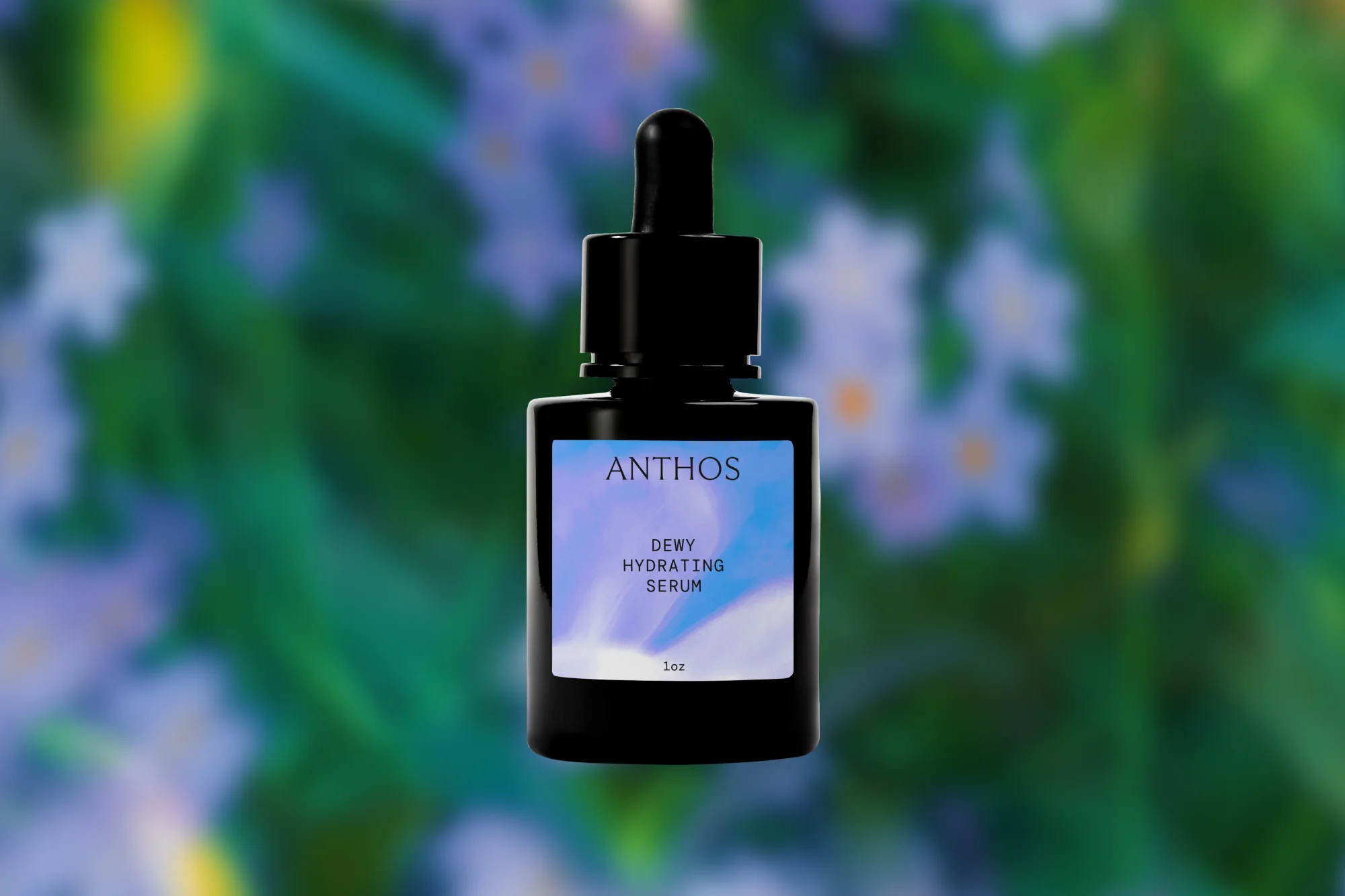Close-up of Anthos dewy hydrating serum bottle with dropper against a blurred green and purple floral background, product shot.