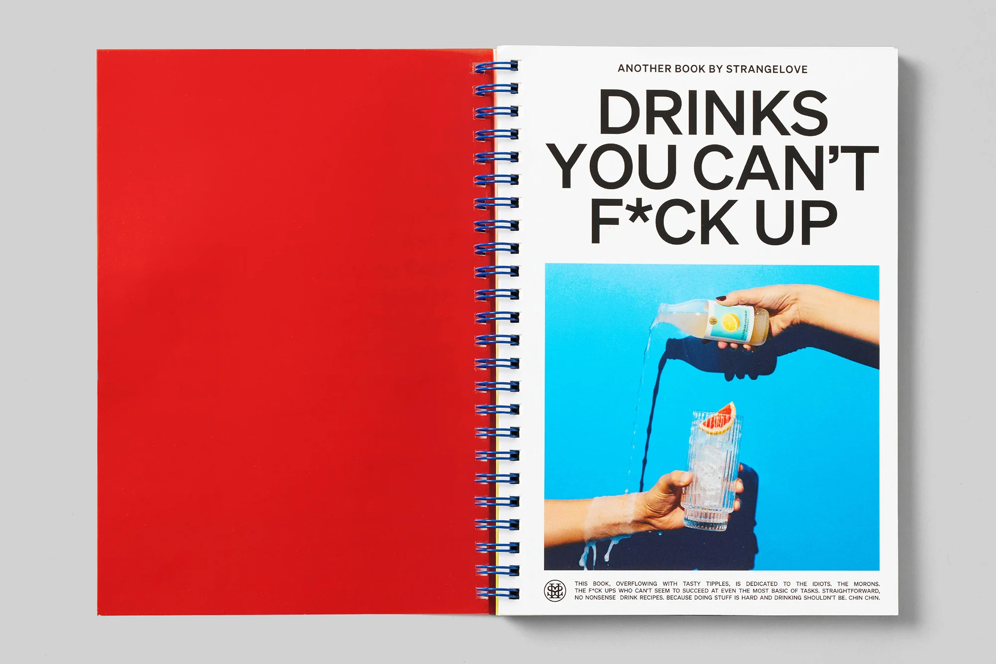 Opened spiral-bound book featuring a recipe and a bright blue background, with the title "Drinks You Can't F*ck Up."