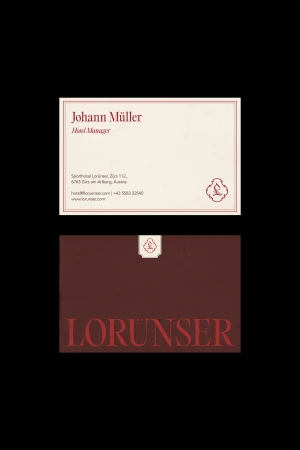 Two business cards showcase elegant designs with maroon fonts and a small logo against a white and maroon background for brand aesthetic.