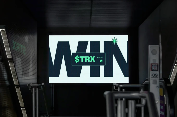 Illuminated digital display in an indoor setting features the word WIN and a graphic symbol for the cryptocurrency TRX.