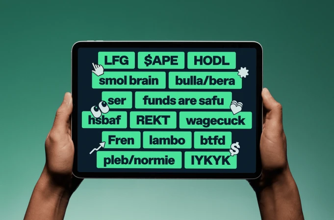 Hands holding a tablet displaying text associated with cryptocurrency and online culture on a green background. Digital device in use.