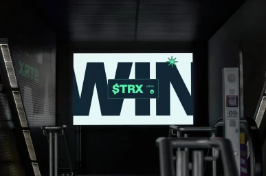 Digital screen displaying graphic typography reading WIN with text TRX inside a dark corridor with architectural details