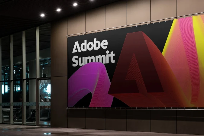 Large Adobe Summit banner with a logo in an urban environment, featuring geometric design elements and modern architecture.