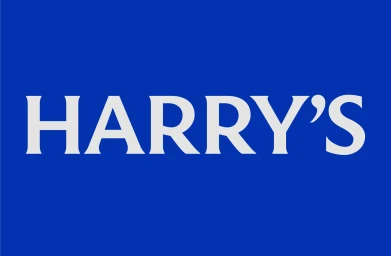White serif typography spelling Harry's centered on a solid royal blue background for brand identity design