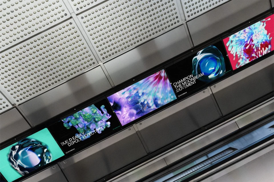 Digital signage display of abstract art panels on a wall with a metallic textured ceiling in an indoor location.