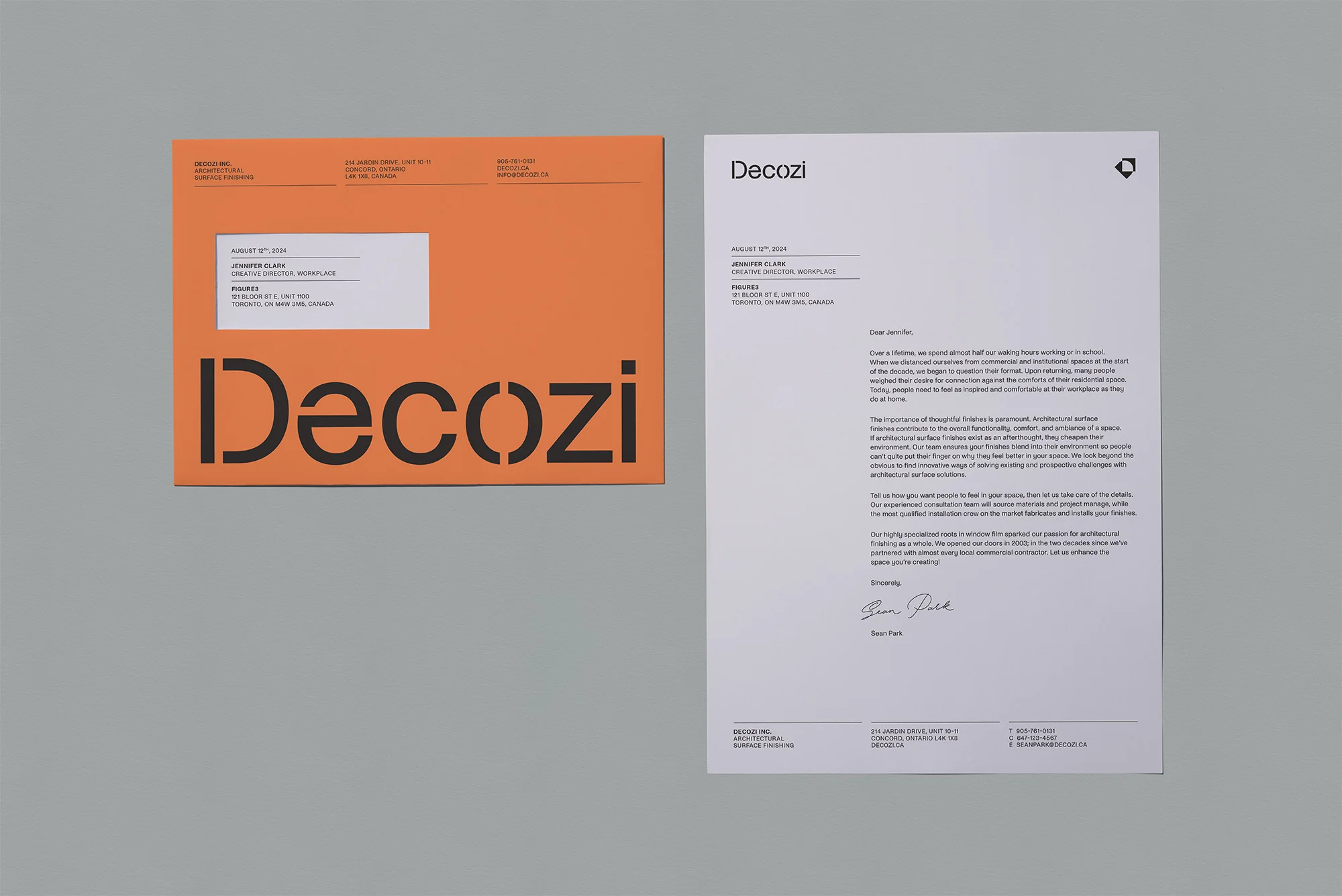 Letterhead and envelope for Decozi architectural surface finishing company in orange and white displaying company logo and contact information.