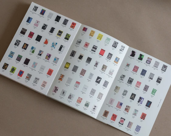 Open booklet featuring multiple small images in grid layout on a white background, showcasing graphic design and typography examples.