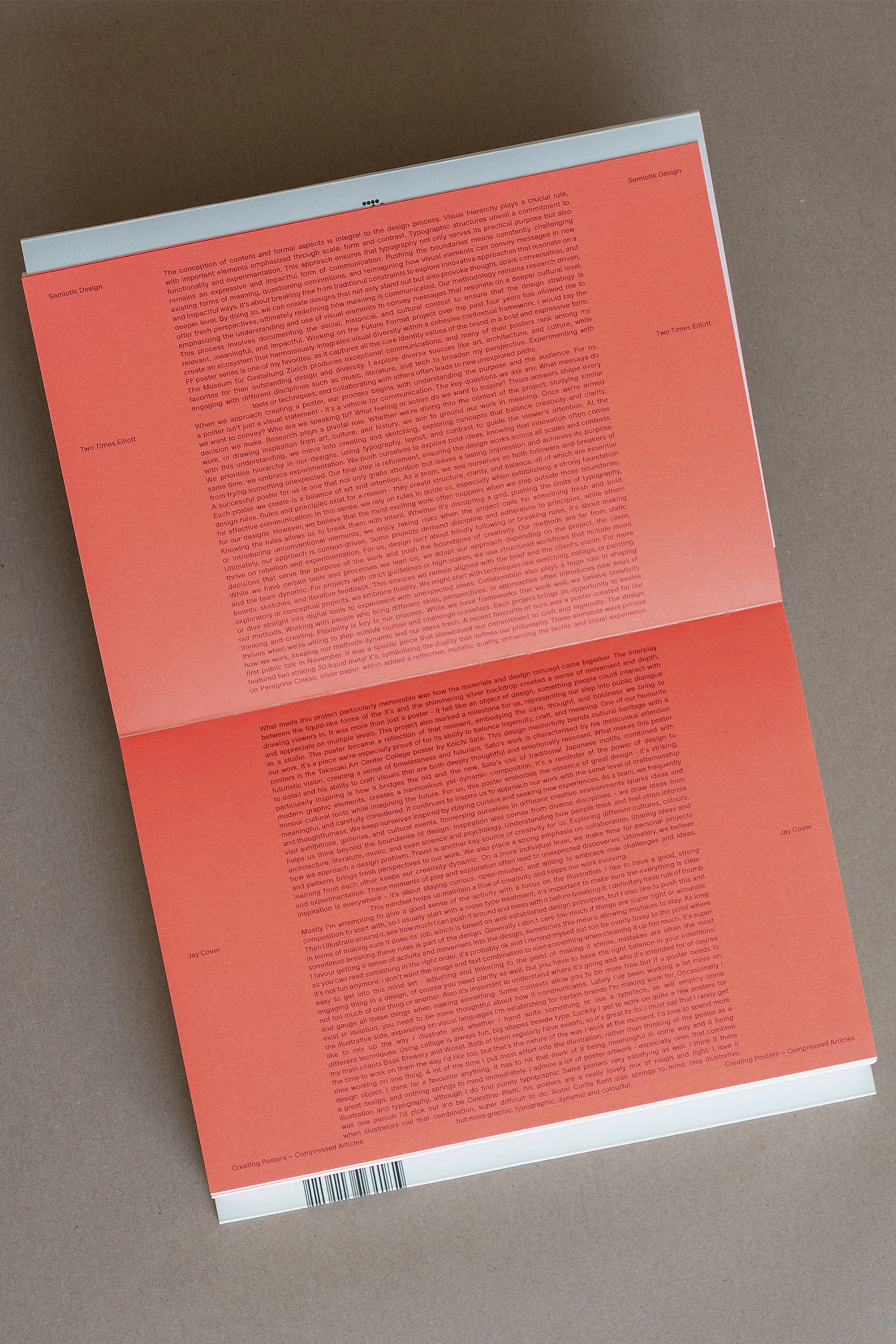 Open book displaying text on coral pages against a neutral background, offering a detailed visual exploration of typography.