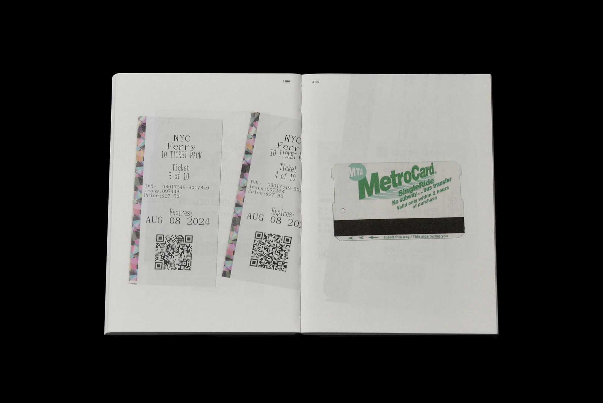 Open book pages featuring two NYC ferry tickets and a MetroCard, all displayed against a plain black background in a studio setting.