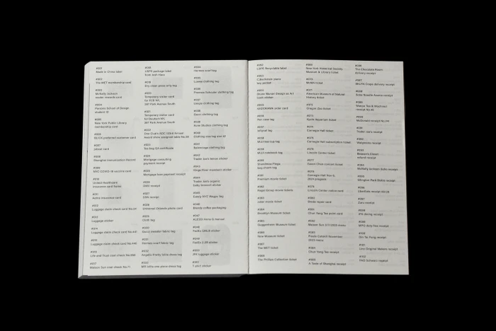 Open book displaying two pages of catalogued text items and index numbers against a dark background