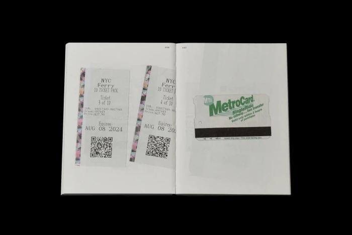 An open book displaying printed pages featuring images of NYC ferry tickets and a green MTA MetroCard.