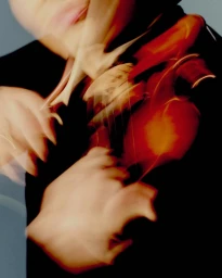 Close-up motion-blurred shot of a musician playing a wooden violin for Omega Ensemble, captured by Saskia Wilson.