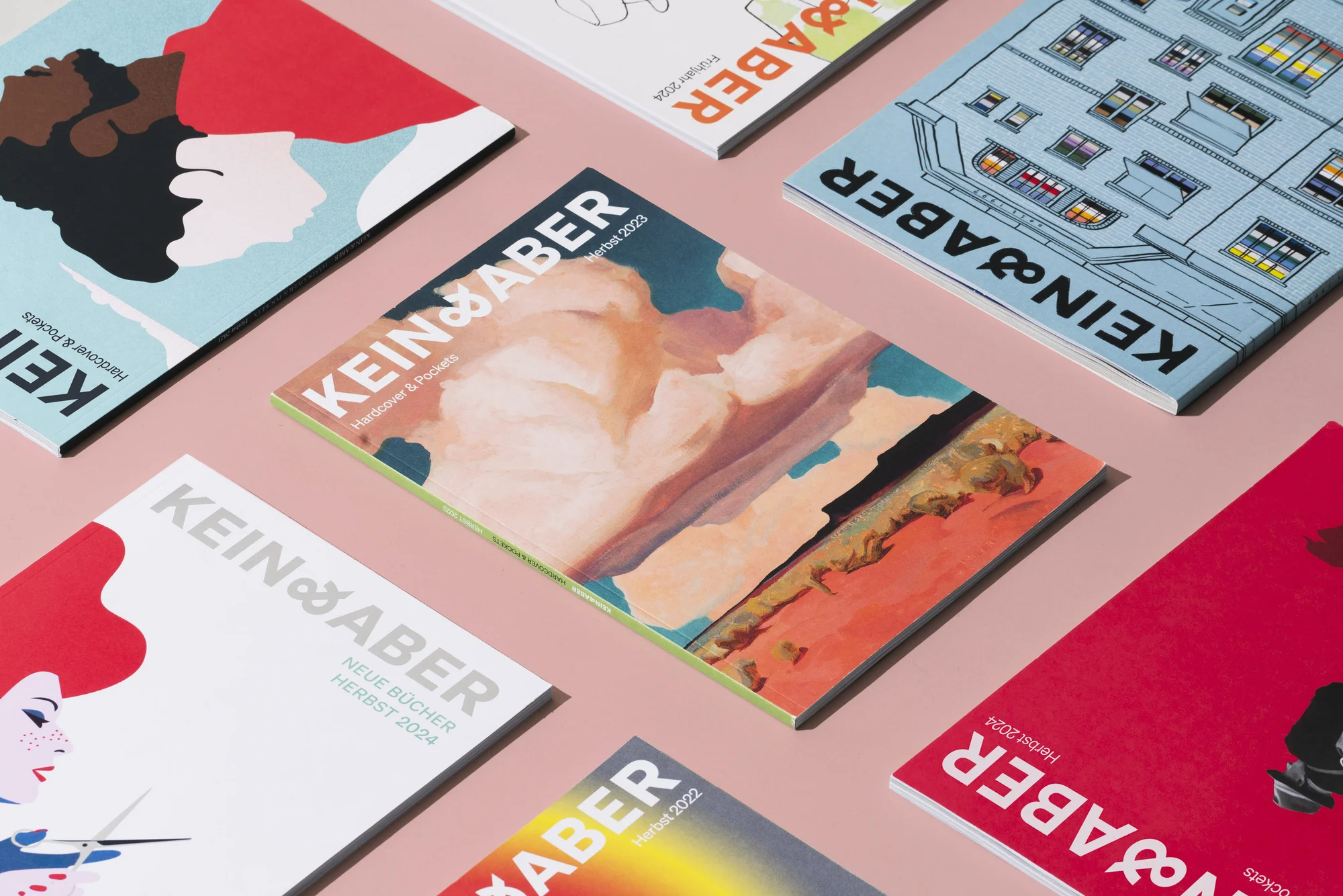 Arrangement of book covers featuring diverse artistic styles and designs, including abstract illustrations, typography, and architectural drawings.