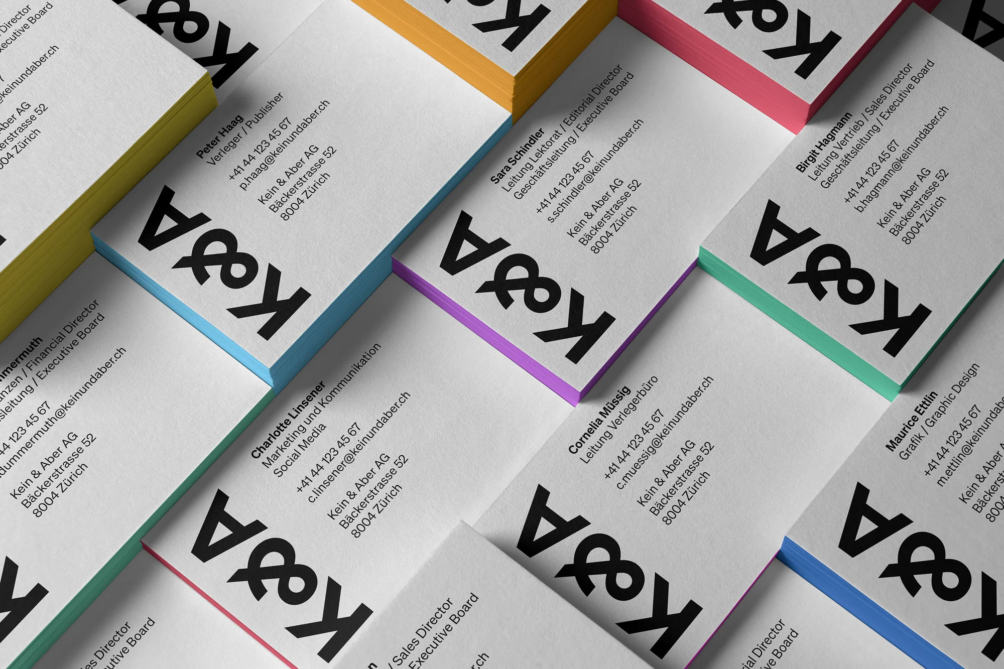 Stack of colorful business cards with K&A logo, close-up product shot for graphic design, print, and company branding services.