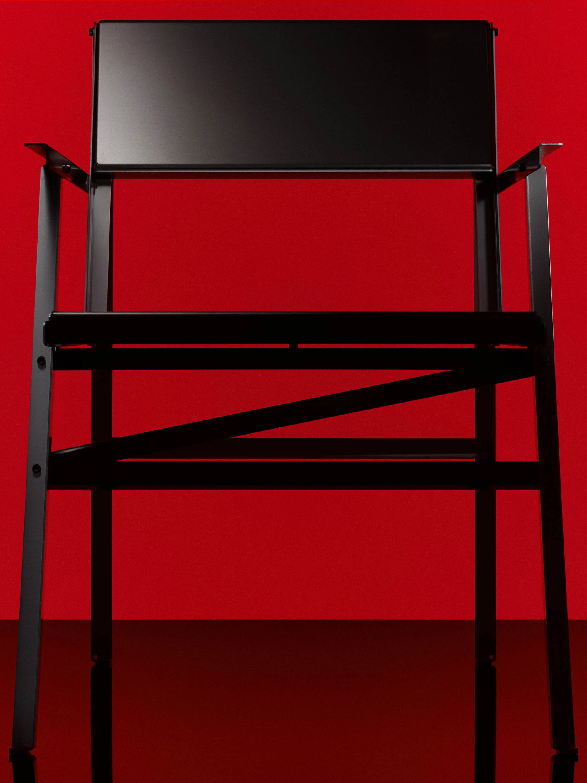 Modern black metal director's chair in front of a bold red background, creating a minimalist and high-contrast studio furniture shot.