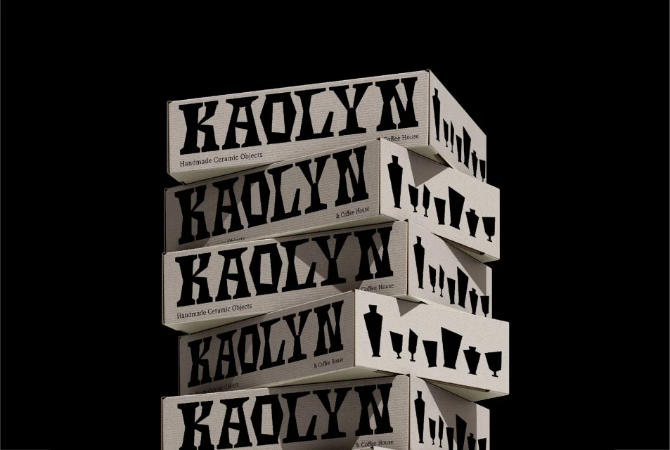 Stack of Kaolyn brand boxes featuring ceramic object silhouettes, promoting a coffee house against a solid black background.