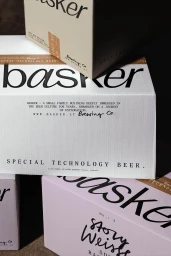 Branded product packaging boxes for Basker beer featuring clean minimalist typography and neutral colour palettes.