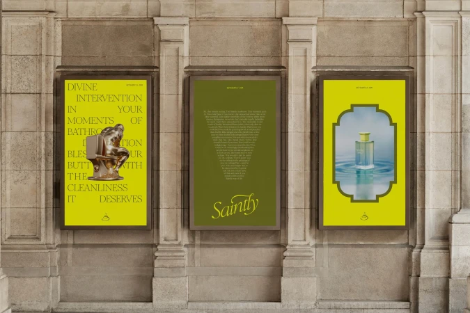 Three advertisements on a stone wall showcasing a bronze statue on a toilet, text, and a perfume bottle, all in an urban setting.
