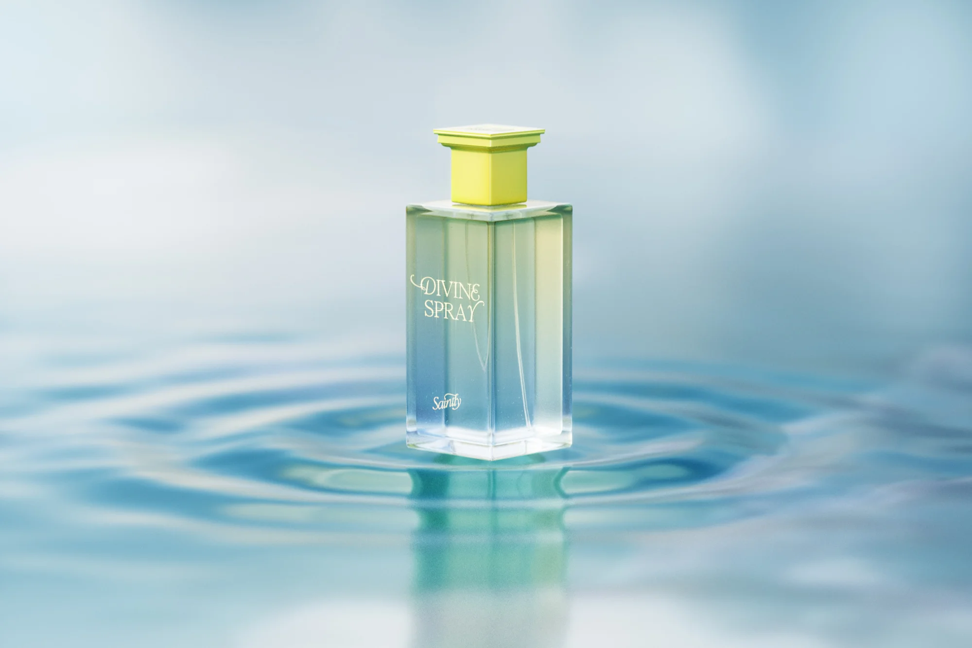 Elegant square perfume bottle with yellow cap on reflective water surface, soft blue background, beauty product advertising.