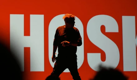 Silhouette of a man standing against a vibrant red backdrop with large white typography for POV Budapest Brand Identity.